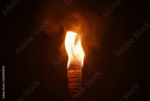 burning match on a black
