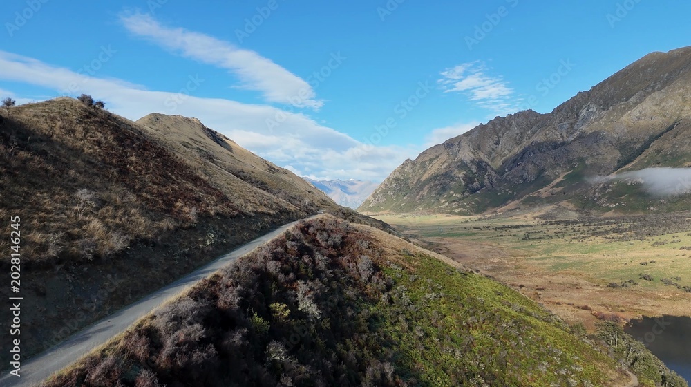 Fototapeta premium Aerial View of a Winding Mountain Road Through Queenstown Valley