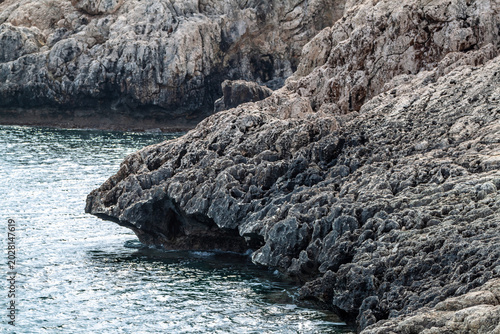 Photos Steep weathered coastal rocks and cliffs at Cape Greco