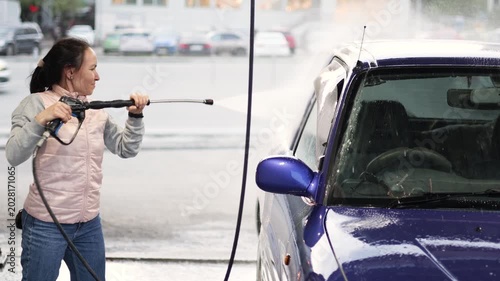 Watch the transformation as a woman carefully washes her blue car. The routine provides a sense of satisfaction and pride, underscoring the joy of taking care of your prized possession.
