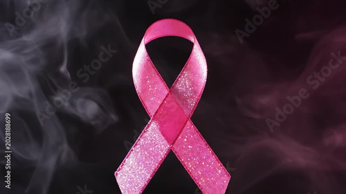 Sparkling pink ribbon for breast cancer awareness with smoke