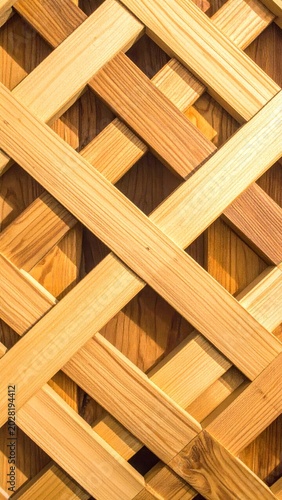 Abstract wooden lattice pattern with interwoven planks creating a geometric design