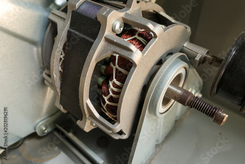 Photos Close up view of internal electric motor parts showing copper wire coils metal c
