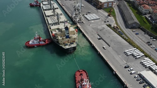 Tugboats guide tanker into Koper harbor with wide reveal