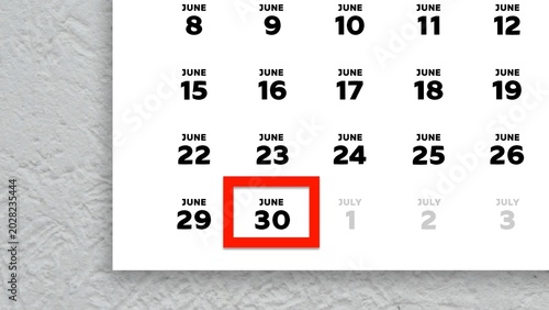Photos Close-up of the date June 30th marked with a red cursor on the wall calendar 202
