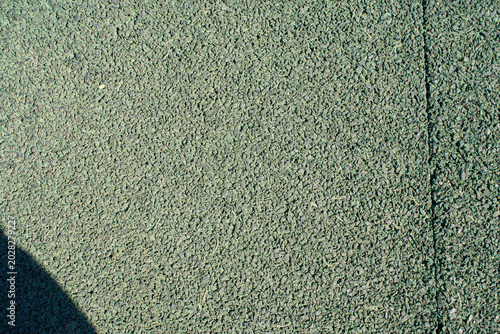 Granular green rubber crumb surface texture close up