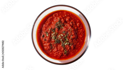 Photos Red tomato sauce with herbs in glass bowl