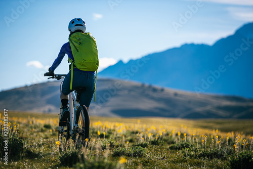 Mountain biking on flowering grassland mountains