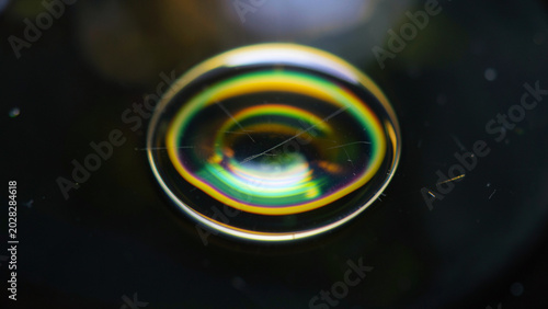 Macro view of thin film interference displaying vibrant spectral colors on black