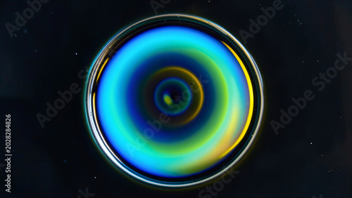 Liquid Droplet Displaying Intense Cyan and Green Concentric Rings