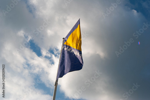 Tableau sur toile The national flag of Bosnia and Herzegovina featuring a blue field, yellow triangle and white stars, symbolizing unity and national identity