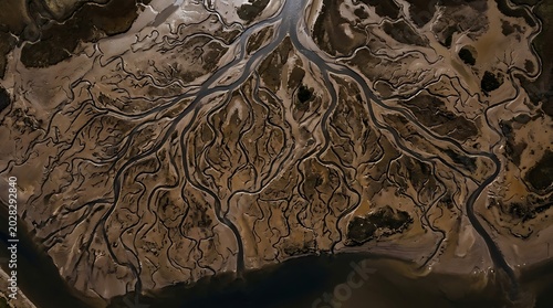 Aerial drone view of a dry river delta with branching waterways, arid landscape