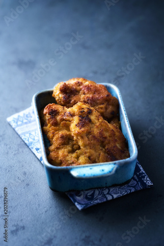 Fried chicken breast on a stone background. Soft focus.