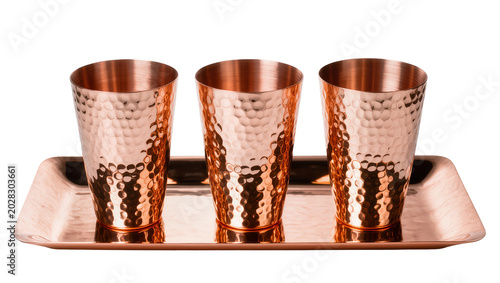 Canvas Print Three hammered copper Moscow Mule mugs on copper tray