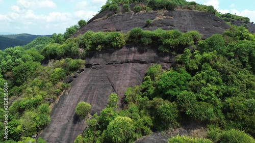 Tropical mountain landscape, steep rock face with dense jungle foliage