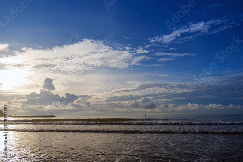 golden morning light on wet sandy beach, sunrise sidelight coastal photography, warm sunlight ocean waves tropical beach