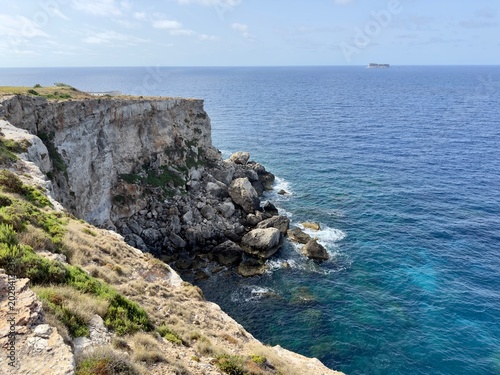 Scenic view of Mediterranean sea and rugged cliffs with a small island in Malta