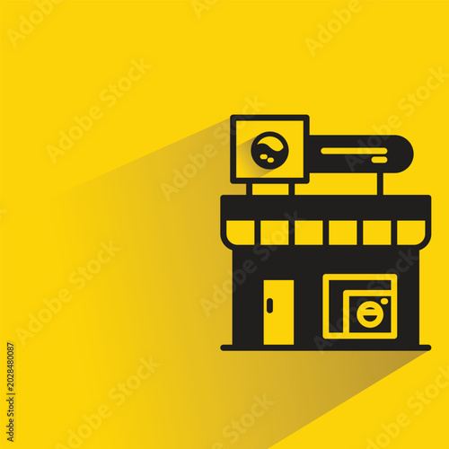laundry shop with shadow on yellow background