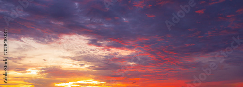 Photos Dramatic Sunset Sky with Fiery Orange and Purple Clouds,A breathtaking sunset view featuring a dramatic sky filled with vivid orange, fiery red, and deep purple clouds, creating a stunning natural