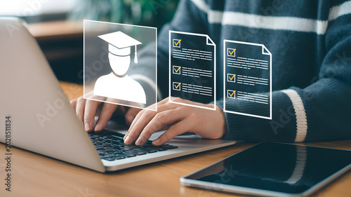 Person typing on laptop with education icons floating above keyboard representing online learning and academic success