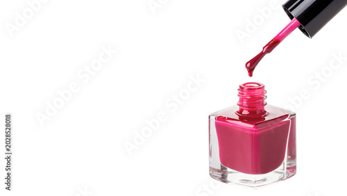 Fotografie A single open glass bottle of vibrant pink nail polish cosmetic brush accessory