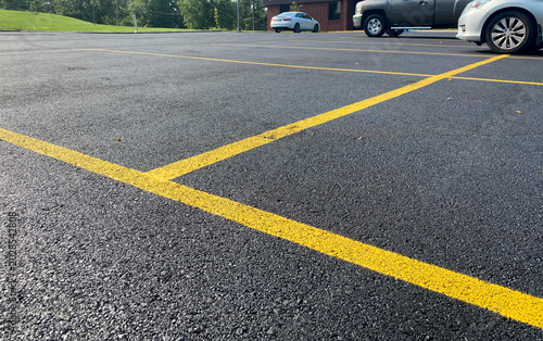 Freshly surfaced asphalt parking lot with painted lines