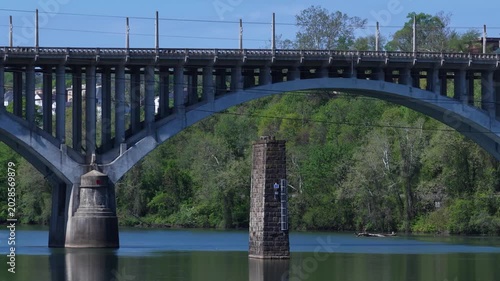 Beautiful Arched bridge crossing peaceful southern river in Fairmont, West Virginia on summer day 