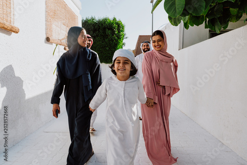 Emirati family standing together and smiling outdoors