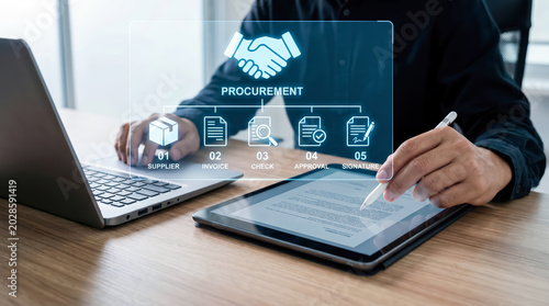 Businessman using digital tablet and laptop for procurement process management in modern office setting
