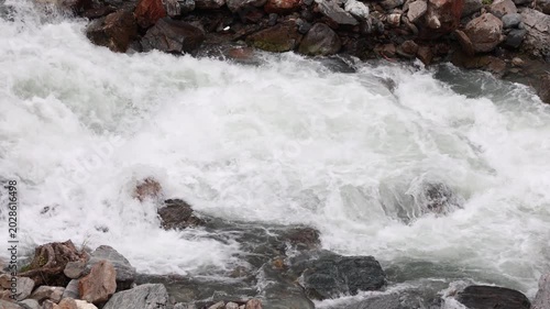 Turbulent white water rapids in a fast mountain river