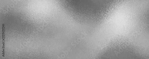 Foto Shiny silver foil metallic texture - glossy gray steel gleaming surface, frosted glass effect with blur glare reflection, bright polished metal material
