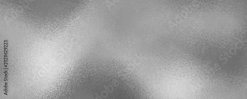 Foto Shiny silver foil metallic texture - glossy gray steel gleaming surface, frosted glass effect with blur glare reflection, bright polished metal material