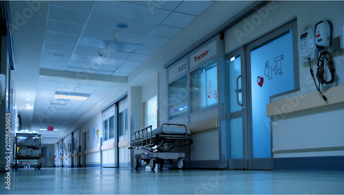 Fotografie Dimly lit empty hospital hallway at night with hospital corridor, medical equipm
