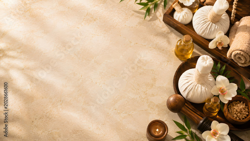 Luxury Thai Spa Flat Lay with Herbal Compress Balls and Massage Oils on Marble Surface
