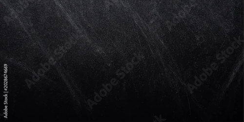 Fotografi A dark, blank black paper texture with a rough, grunge surface pattern that rese