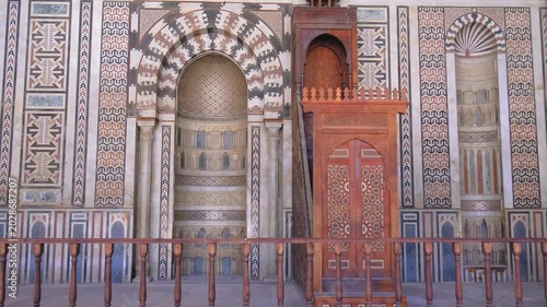 Slow motion upward camera movement inside historic mosque in Cairo, Egypt. Majestic Islamic interior with ornate ceiling, arches, and architectural details captured in cinematic 4K travel footage.
