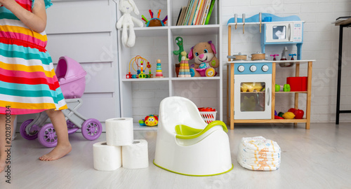 Photography Toddler girl playing in room, potty training readiness concept