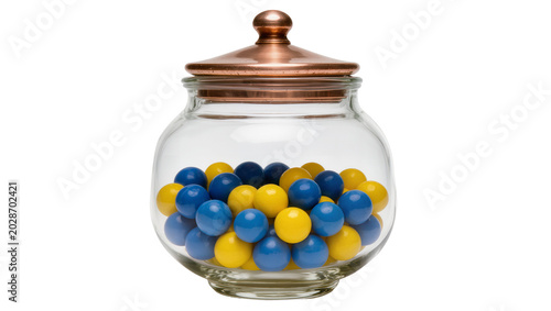 Fotografía Glass candy jar with copper lid filled with blue and yellow gumballs, isolated o