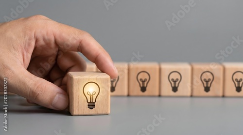 Close up of hand holding an innovative glowing lightbulb cube