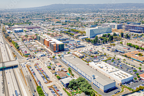 Torrance, California CA August 15, 2024: High Aerial City Drone View toward Harbor UCLA Medical Center around Carson St, Vermont Ave, Normandie Ave, Freeway 110 with Homes, Houses, Streets, Shops