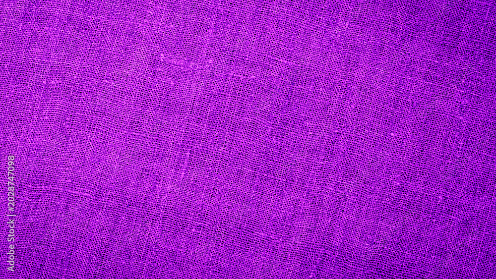 Fototapeta premium Close up view of purple fabric texture with patterns and weave details shown in bright light at home