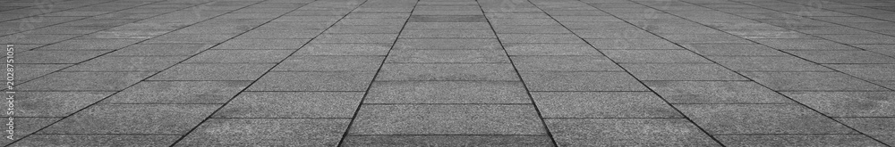 Obraz premium empty stone floor top in perspective. grey tile floor background in perspective view. line. empty copy space stone street. pavement. Granite outdoor tiled floor. gray granite. Marble texture