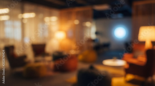 Blurred lounge area featuring armchairs tables sofa and glowing television screen