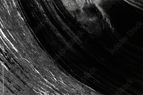 Photos Jagged lines of light and dark streak diagonally across a rough, textured surface showing grain and subtle striations creating an abstract pattern