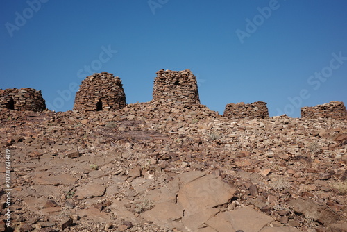 Photos Old stone ruins on a dry rocky hill under blue sky