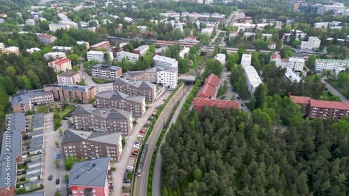 Aerial or cinematic footage of the Pohjois-Haaga and Pikku Huopalahti train station area in Helsinki, Finland.
