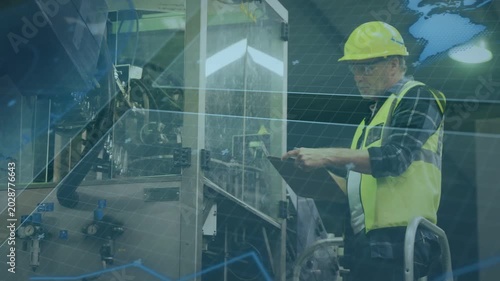 Senior worker standing on step tapping tablet, initiating factory inspection, checking clear panel