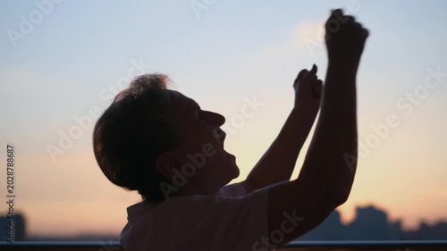 A desperate, lonely elderly woman screams into the void at sunset