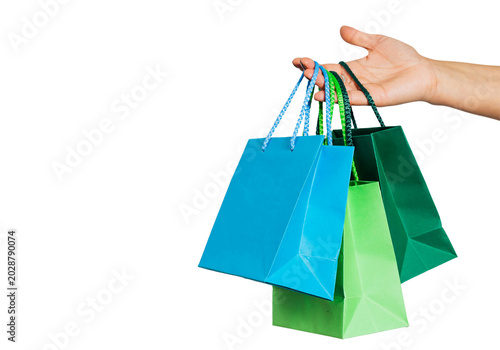 Hand holding colorful paper shopping bags, retail shopping concept isolated on transparent background PNG