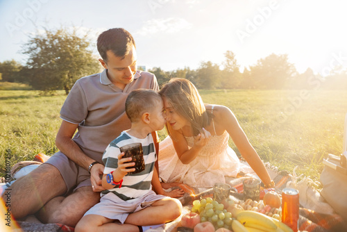 Bild auf Leinwand Tender family enjoying meaningful moments in sunny meadow